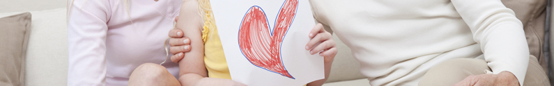 females holding a picture of a heart